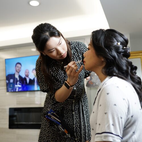 Sabrina Lo doing makeup for a women