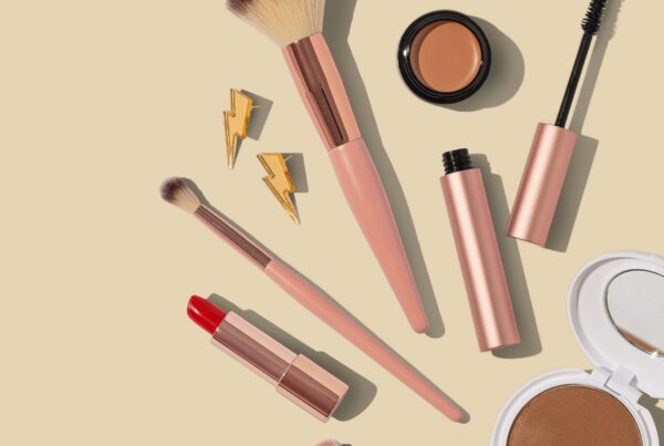 Professional makeup artist's kit laid out showing brushes, foundation range, and essential products