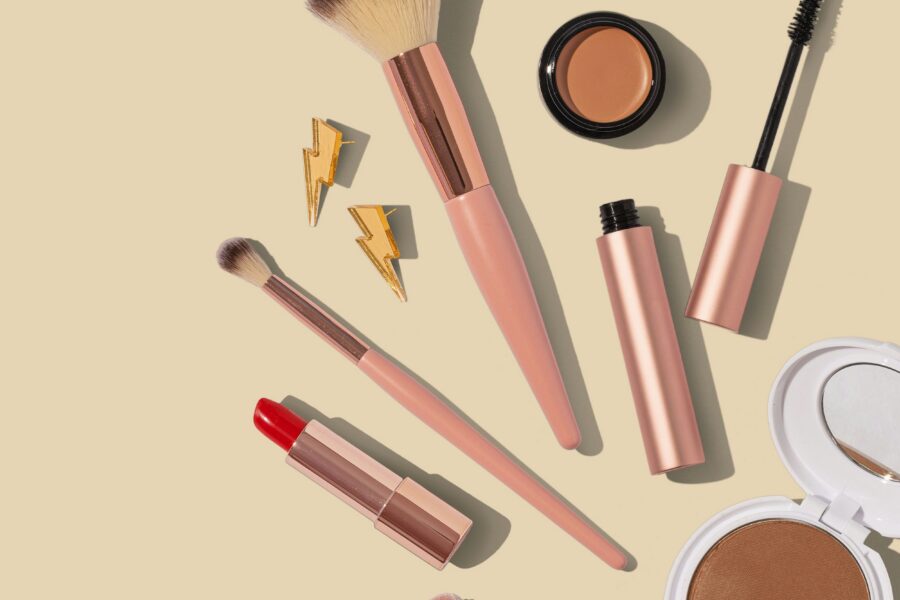 Professional makeup artist's kit laid out showing brushes, foundation range, and essential products